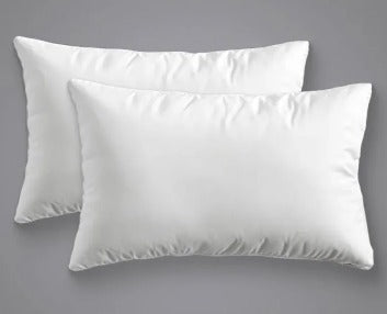 Set of 2 soft white bed pillows on grey background